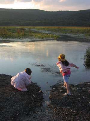 two children at a riverbank