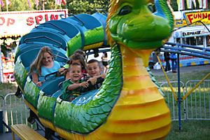Children on roller coaster at a county fair